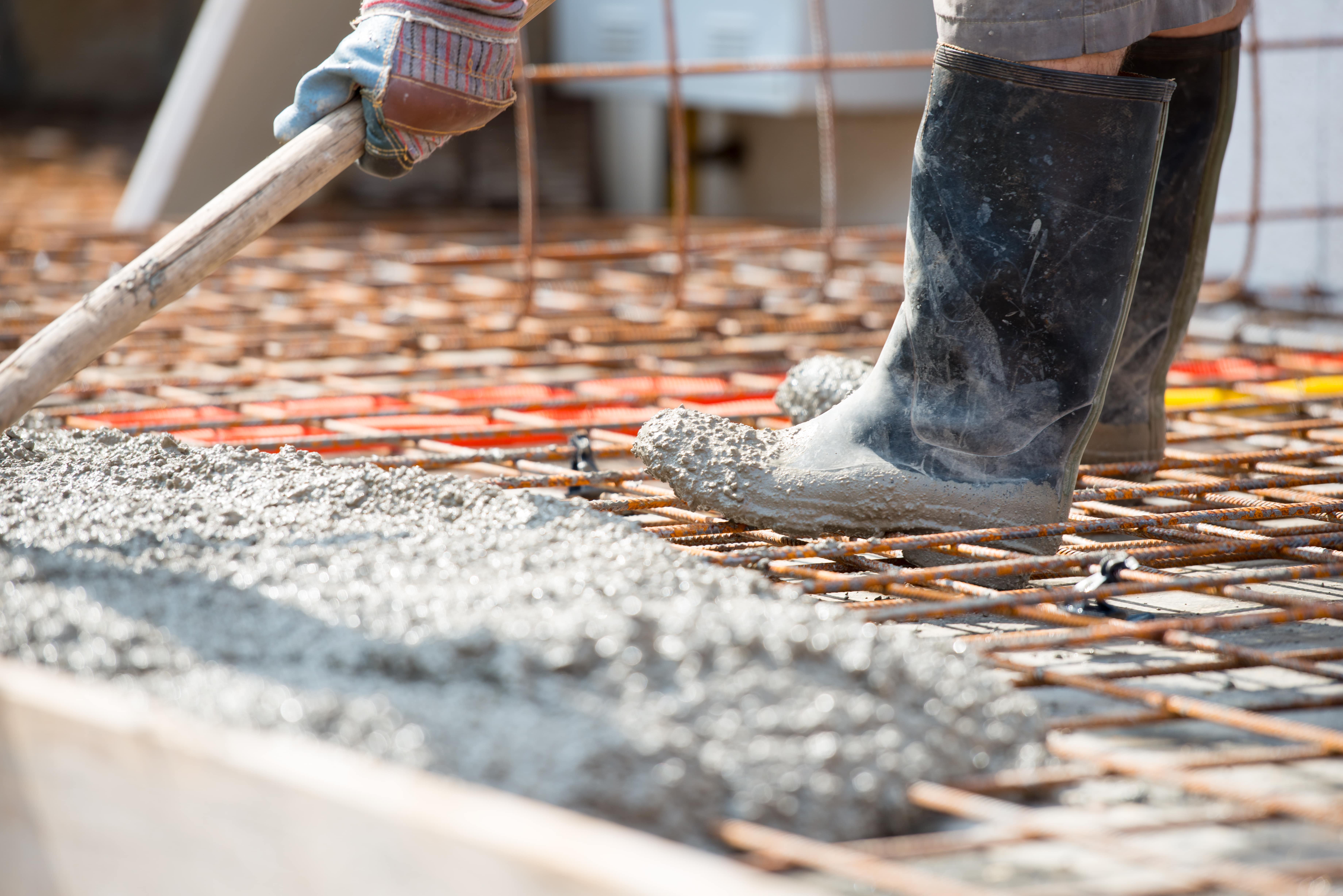 worker-pouring-concrete-mix-at-home-foundation-min.jpg